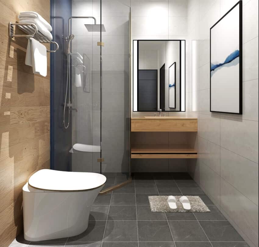 Bathroom with tile floor and walls, towel rack mounted on wood wall, and an incinerating toilet