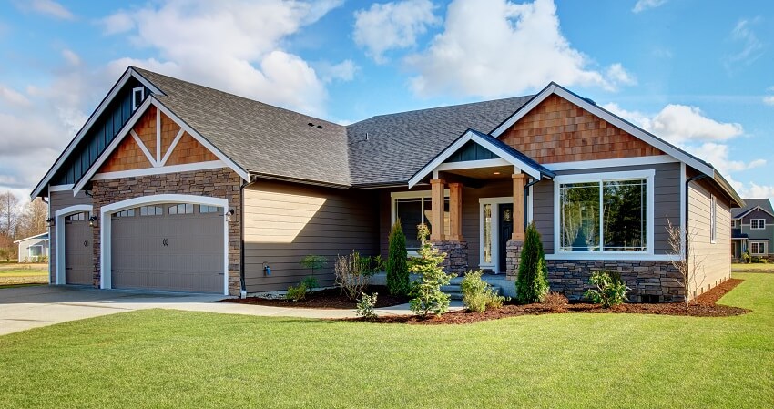 House with walkway leading to a bungalow porch,and an expansive lawn