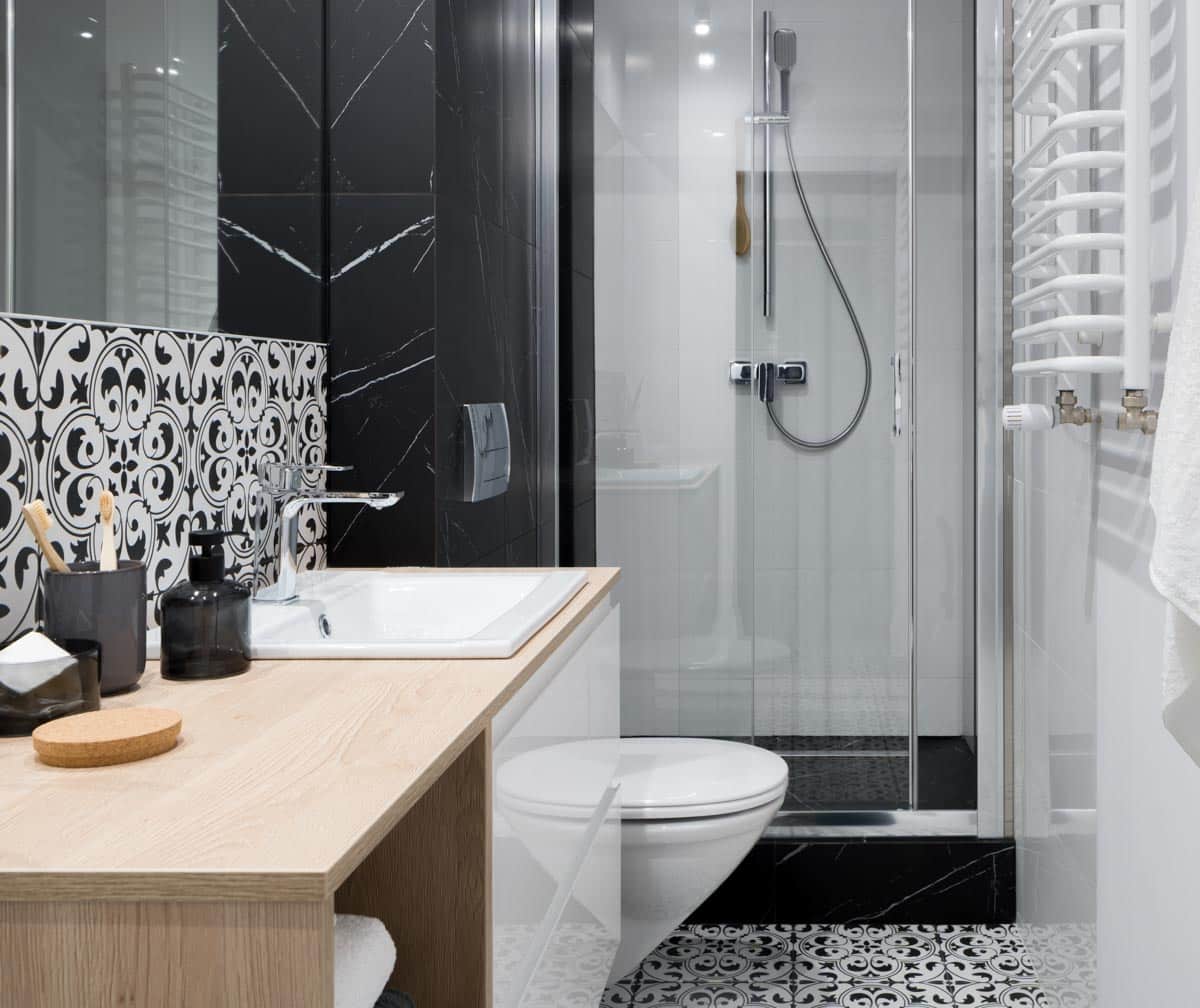 white and black bathroom with wood counter